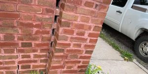 How do I maintain a brick retaining wall or stone pillar?
